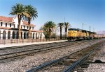 Union Pacific SD60M #6102 (SD60M) leading a container stack train past the depot